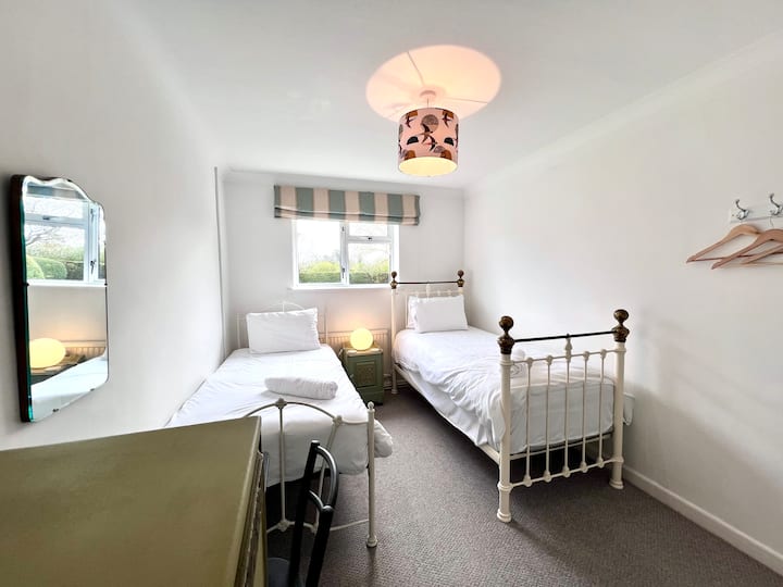 Bedroom 5:  Two standard full-sized single beds, garden view, cupboard space and desk.  Close to bathroom including shower.