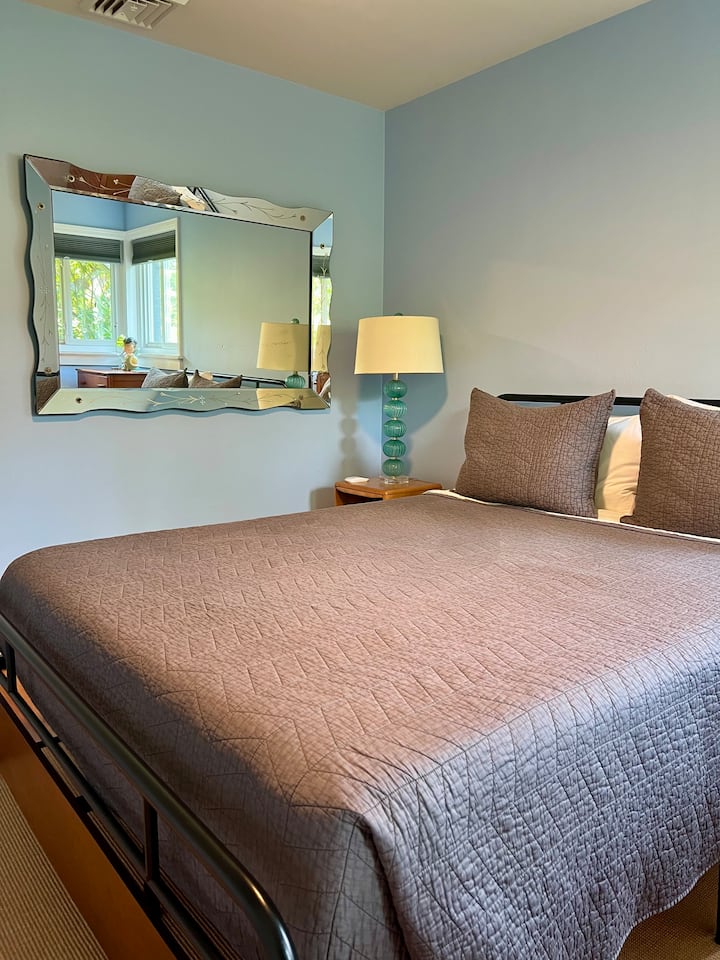 This bedroom offers a queen bed.  It is on the road side of the house, but as you can see the plantings provide plenty of privacy.  In addition, there are room darkening shades in all of the bedrooms.