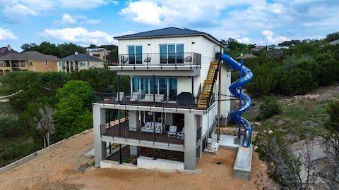 Lakefront w dock, volleyball court & 4 story slide
