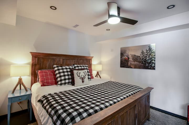 King-sized primary bedroom on the lower level with a cozy cottage feel and easy access to the lake.