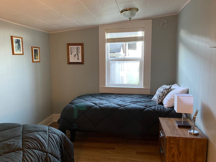 "Beach Pebble Room" with Bay view has two standard Single beds for children, plus nightstands with drawers and bedside lamps with built-in USB for charging devices. There are allergen protectors on all mattresses.