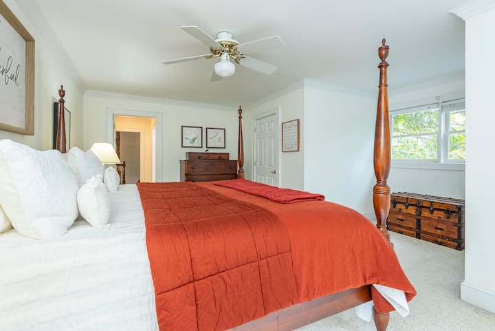 Second-floor ensuite bedroom with a king-size bed, closet, bathtub, walk-in shower, and dual sinks