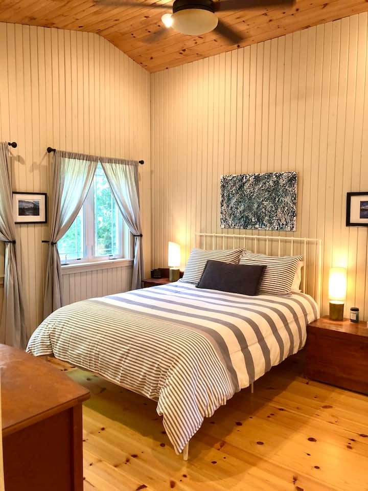 The Primary bedroom with direct access to the bathroom features a comfy Queen bed and luxurious comforter, quilt and linens.