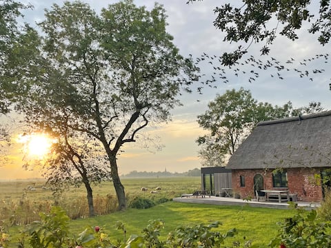 thatched roof house "Altes Schulhaus" with a view