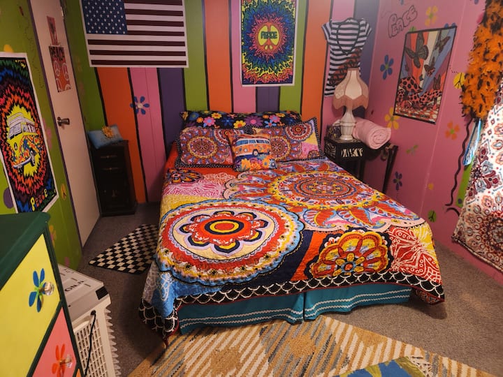 Guest bedroom with a queen bed in regular lighting.