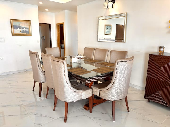 Large, airy dining area with grand interiors that seamlessly connect with the living space for a warm, social experience.