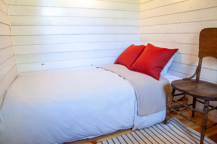 Twin bed in cozy side bedroom.