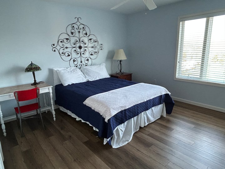 Queen-sized bed with dresser, work desk and chair, and dresser.  Marina and lake view 
