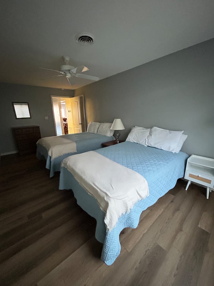 Two full-size beds with dresser and large walk-in closet