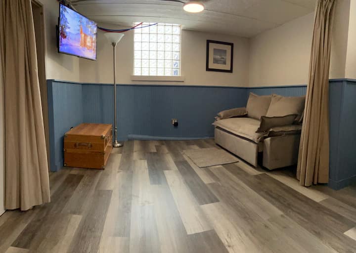 Downstairs bedroom includes a queen size sleeper sofa and single bunkbeds. However, there’s a curtain to divide the space for privacy. This room also has its own television, game storage area and wall mounted heater. Flooring also had been updated.