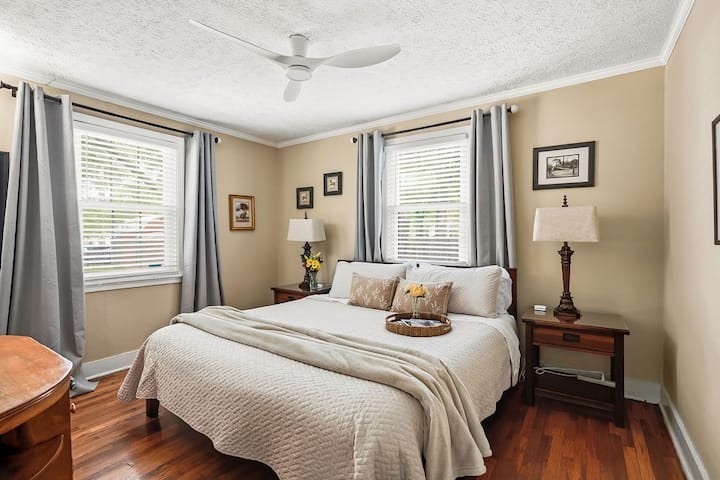 Bright, cozy bedroom with natural light and warm wood floors