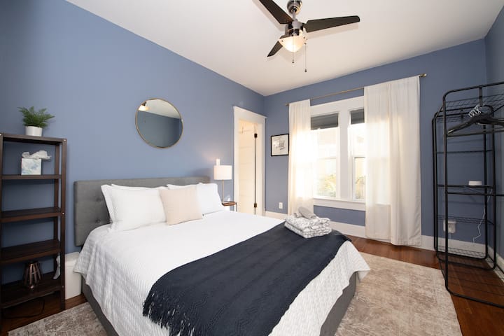 Primary bedroom with connected bath, which has a large soaking tub and double shower heads within tile shower. This bedroom is on the main floor at the back of the house. 