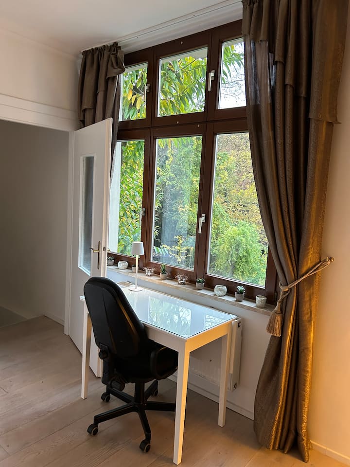 Sehemu ya kufanyia kazi kwenye chumba cha kulala, dawati dogo lenye paneli ya kukunjwa. Mapazia yanaweza kufungwa kwenye dirisha. 