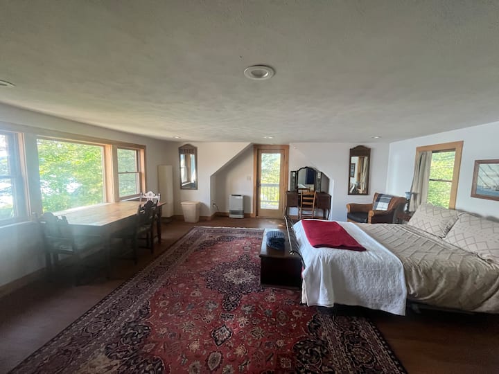 Chambre 1/4 : lit queen, vue sur le lac, terrasse privée et entrée privée.