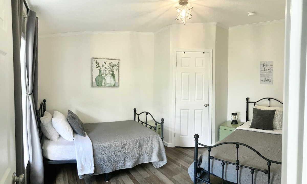 3rd bedroom featuring (2) twin beds with cotton sheets, extra blankets, dresser and blackout curtains