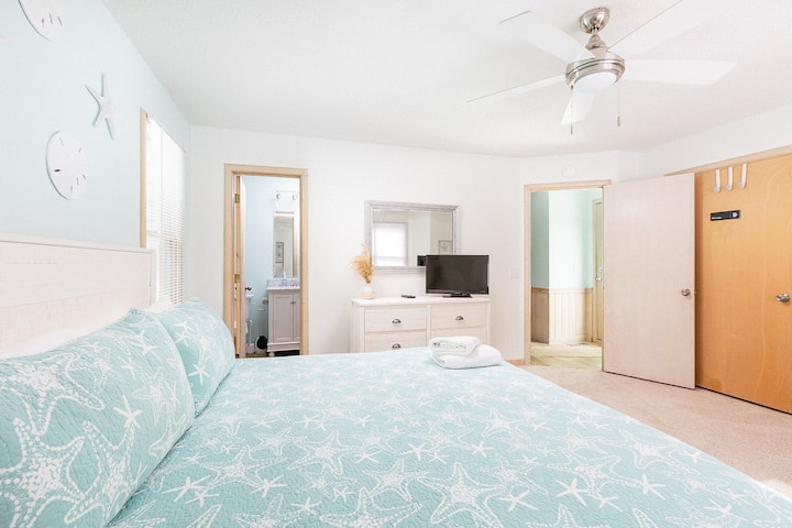 Bedroom 3 (king) is on the middle level and includes an attached full bath. There is also a baby equipment available for guest use (actual items may differ from those shown).