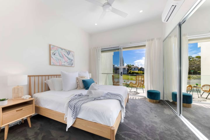 Luxurious master suite with elegant coastal styling throughout