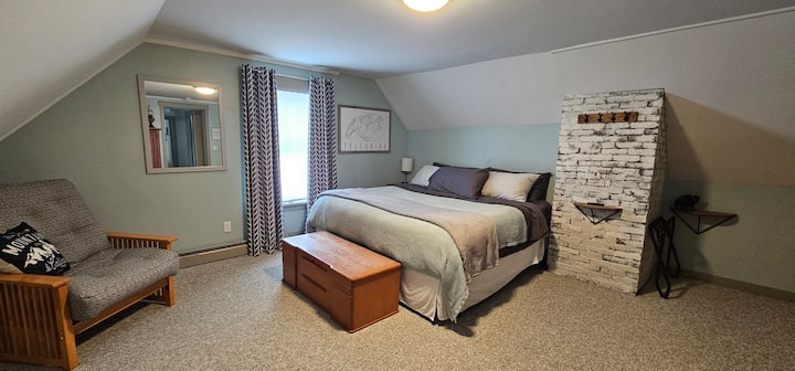 Large second floor bedroom with one king bed.  Innerspring hybrid mattress, moderate firmness. 