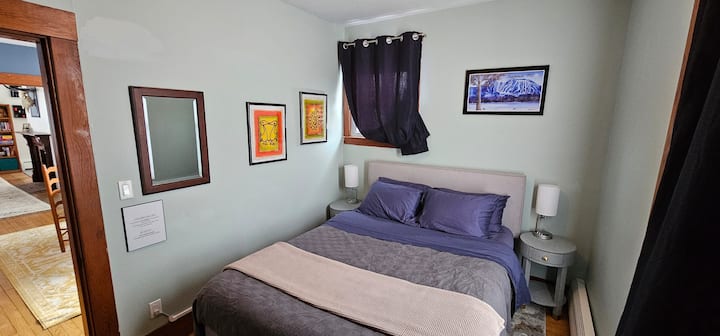 Queen bed. This mattress is memory foam with moderate firmness. Firm at first, then you sink in. Large closet with ironing board and iron. Access this first floor bedroom from the small dining room or the hallway. 