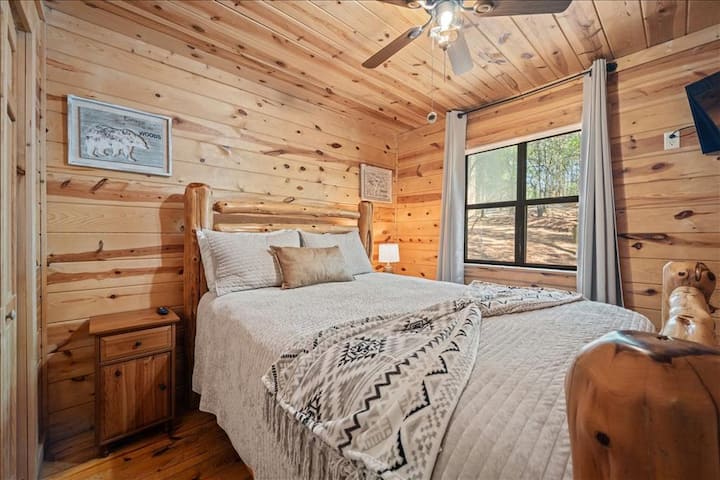 Queen bedroom with Smart TV and closet.
