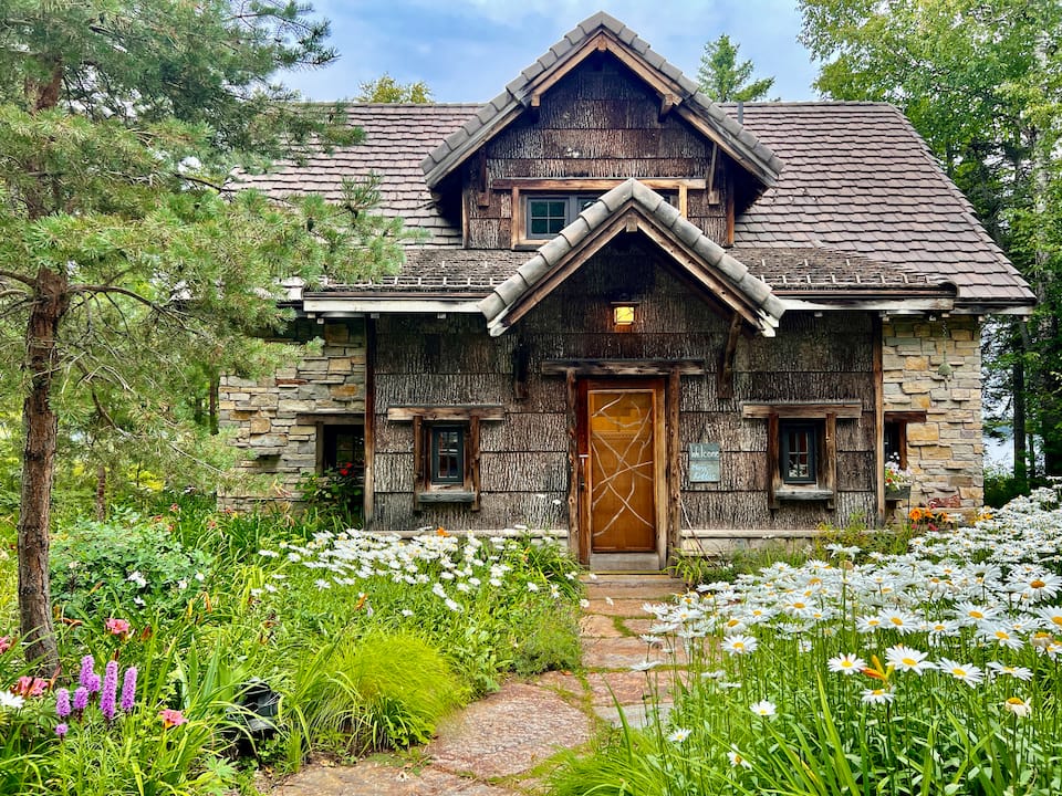 A stone-and-bark cabin on Lake Medora, Eagle Harbor Township, Michigan, United States, photo 1 of 10