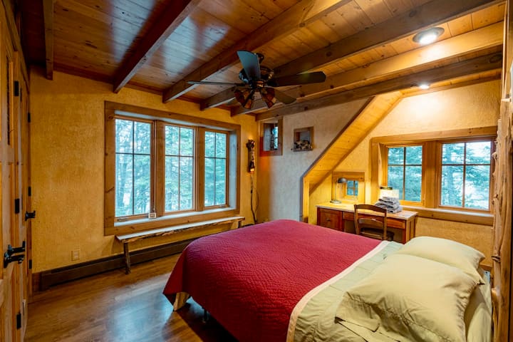 Queen bed.  Lake views on two sides.  Attached bath.  Desk area.