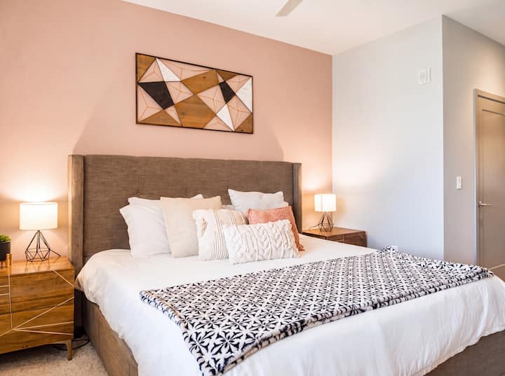 Cozy modern bedroom with plush king bed and warm designer accents