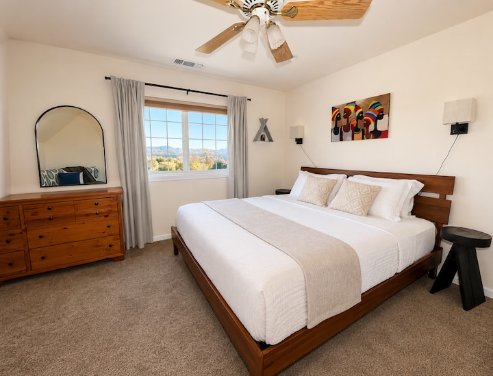The king bed with 4 pillows for comfort preference, black out curtains. Additional blankets are available in the dresser.