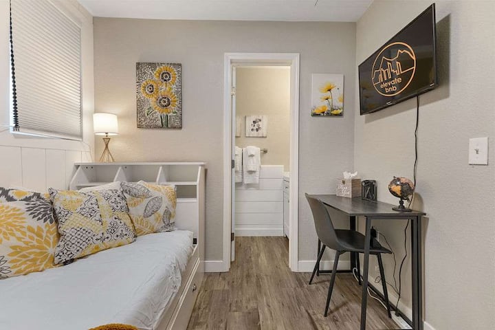 The second bedroom has a single bed and attached half bathroom.