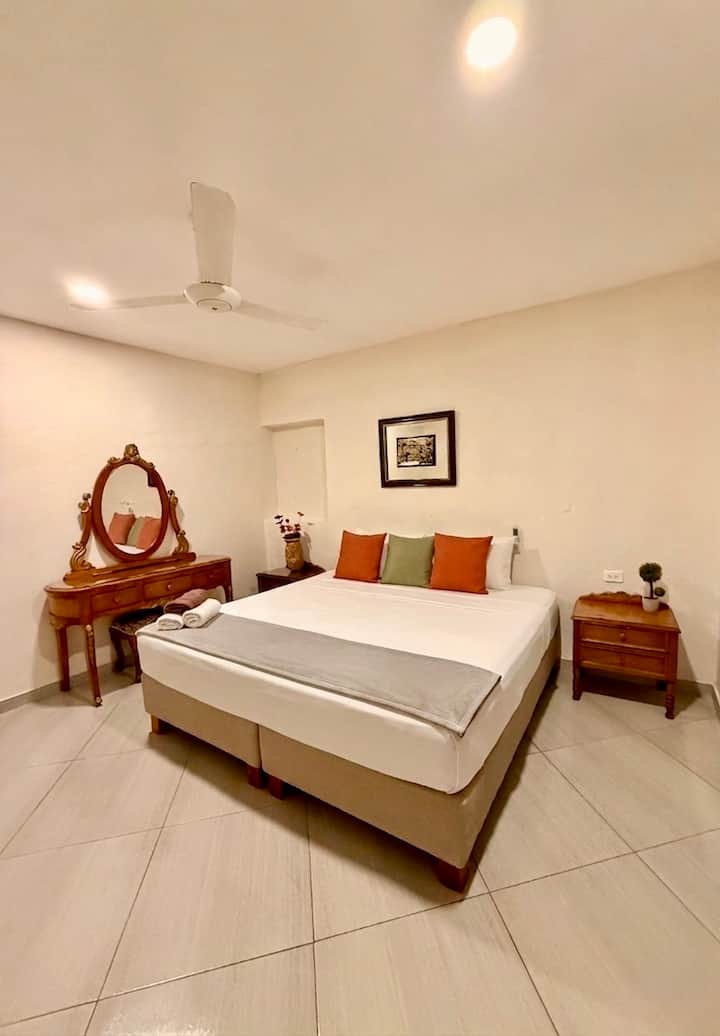 Comfortable bedroom with a king-size bed in a private colonial house in the historic center of Cartagena, perfect for couples looking for a stay in Cartagena's coolest neighborhood: Getsemaní.
