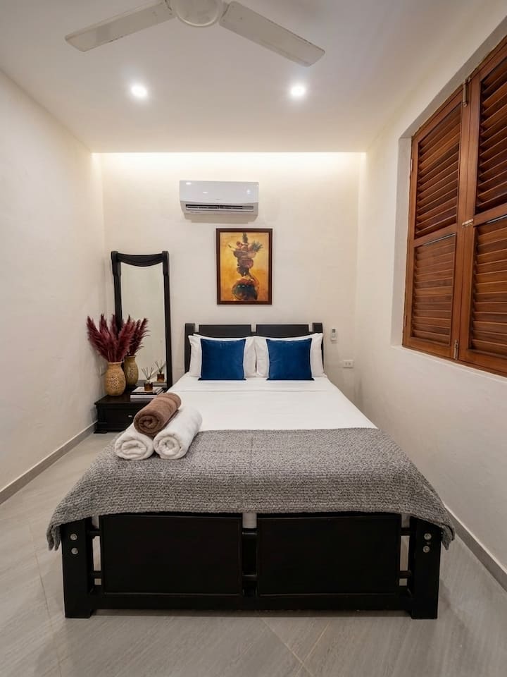 Comfortable bedroom with a double bed in a private colonial house in the historic center of Cartagena, perfect for couples looking for a stay in Cartagena's coolest neighborhood: Getsemaní.