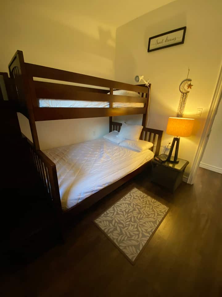 Secondary bedroom facing roadside, bunkbeds with double size mattress on bottom bunk, single on top. Linens not included, mattress covers, pillows and pillow covers are included 
