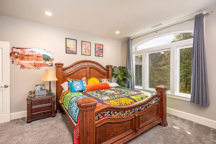 The India Room is based on Colleen's, Tiger's Curse book series. It features a king bed, a desk, a chair, a dresser, side tables, bedding, towels, and various collectibles from her books. 