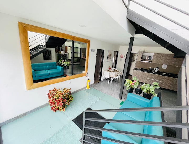 2nd floor of the house has a shared kitchen and a place to rest on a sofa while you wait for your check-in