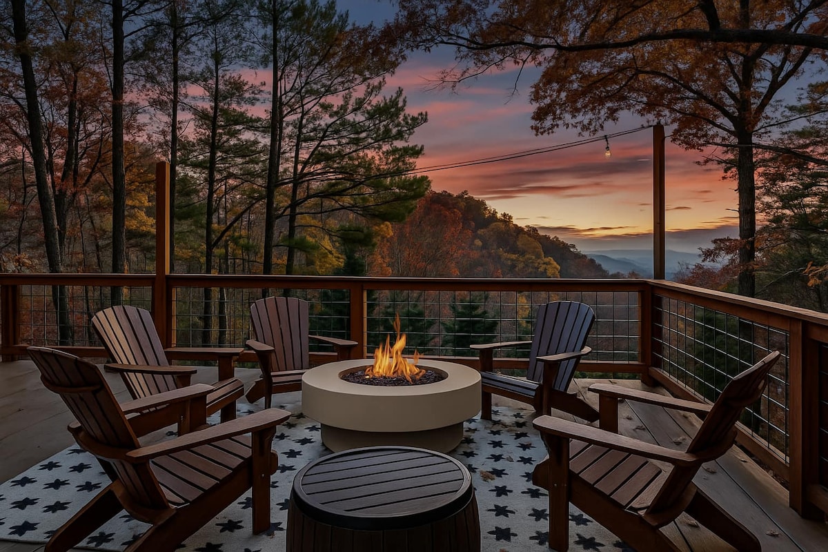 A serene outdoor space features a circular fire pit surrounded by Adirondack chairs, set against a backdrop of colorful fall foliage. The scene is enhanced by a vibrant sunset sky, providing a tranquil atmosphere for evening gatherings.