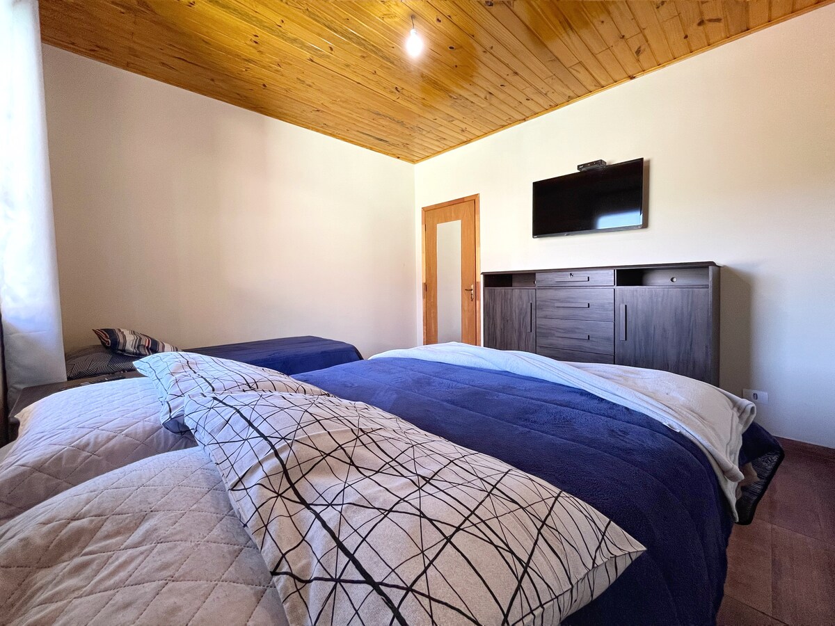 Slaapkamer 2: een tweepersoonsbed, een eenpersoonsbed, een 40-inch tv (open kanalen) en een grote boekenkast om kleding en persoonlijke spullen op te bergen.