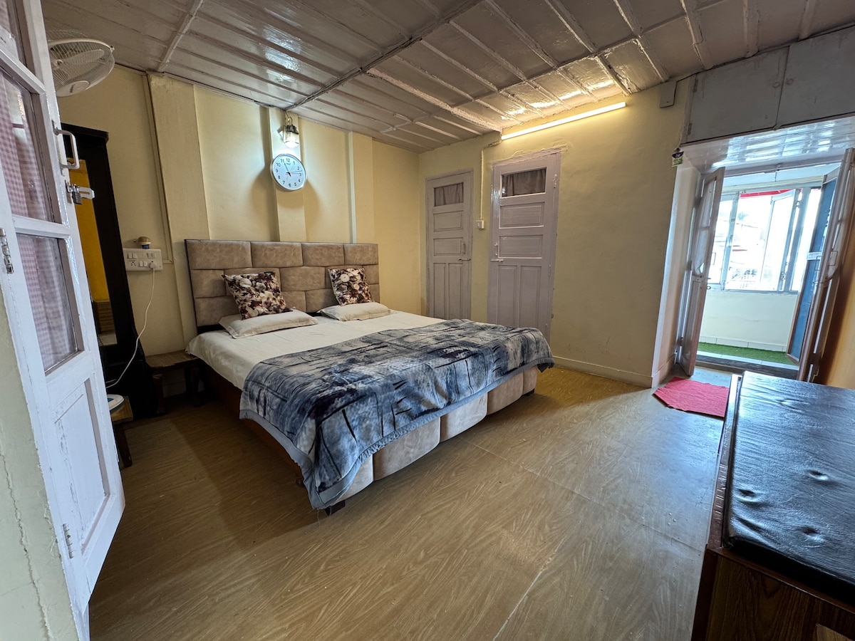 Уютна спалня с плюшено спално бельо и меко осветление разполага с прилежаща баня за удобство, с полуотворено оформление, което насърчава чувството за връзка и сплотеност, идеално за споделено уединение.