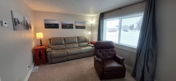 Reclining sofa & recliner in living room. Additional folding chairs available.