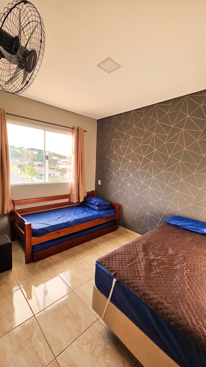 Room on the right, with double bed and double bed, accommodates 4 people.