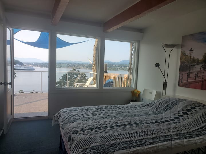 The Master Bedroom 2024.8.10 overlooking deck and south over Departure Bay to downtown.