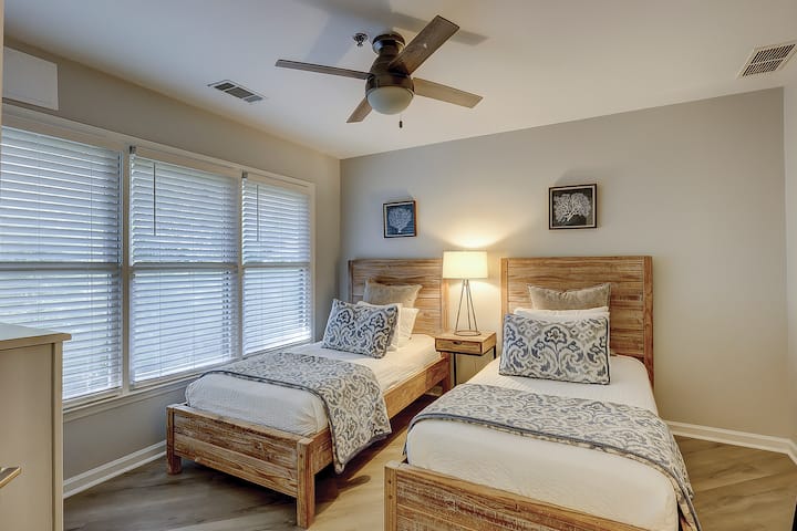 A cheerful room with two twin beds gives family or friends their own comfortable place to recharge.
