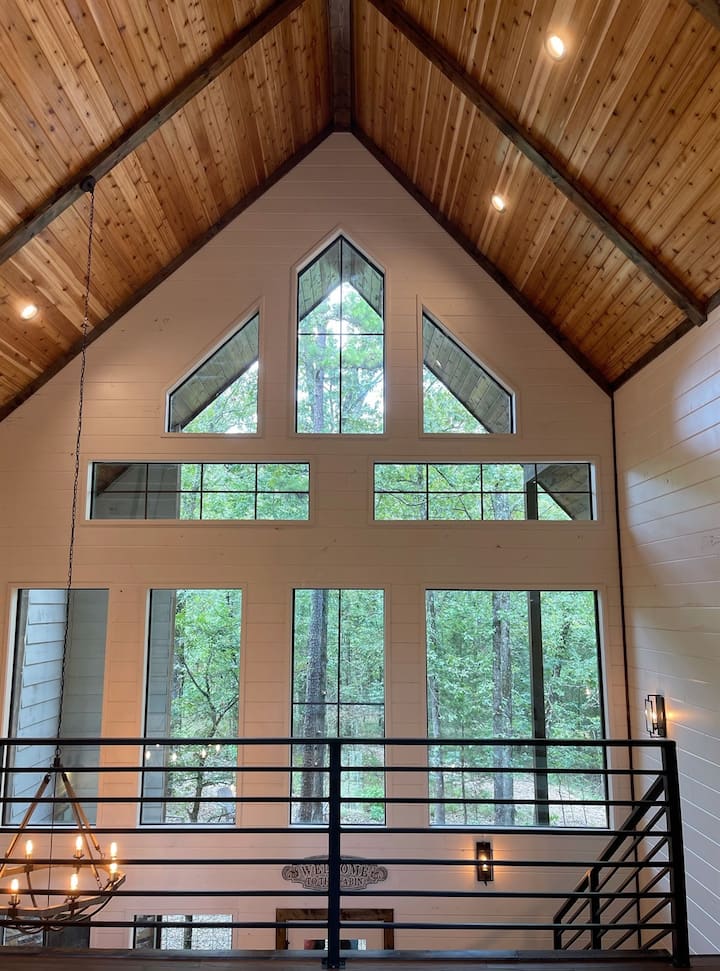 Seated on the super comfy new sleeper sofa, over looking the ping pong table in the loft and through the wall of windows towards the Ouachita National Forest.