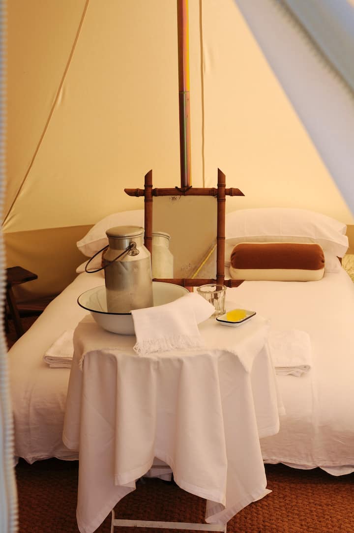 Luxury 5m canvas bell tent with a double bed and an optional single, fold out bed. 
All beds are made up with fresh linen and lambswool blankets.
Wood burning stove.