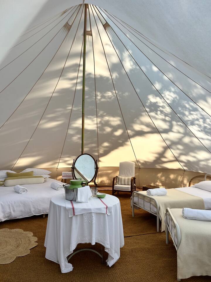 The magnificent 7m tent sleeps four on 1 x Super kingsize bed and 2x full singles - there's plenty of room for an extra camp bed too.
Woodburner.
Wash table.
2x armchairs.