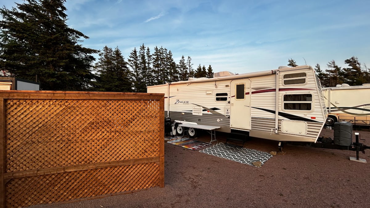 Camper tucked behind its own privacy screen