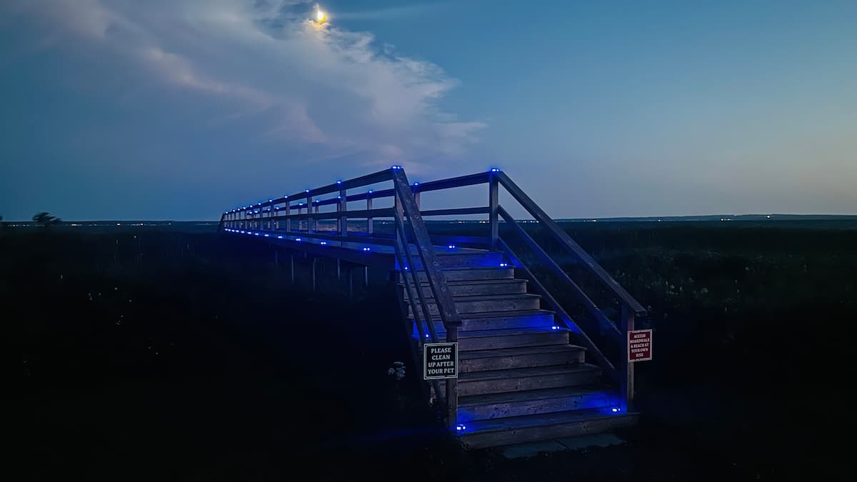 Boardwalk stairs glowing under the stars