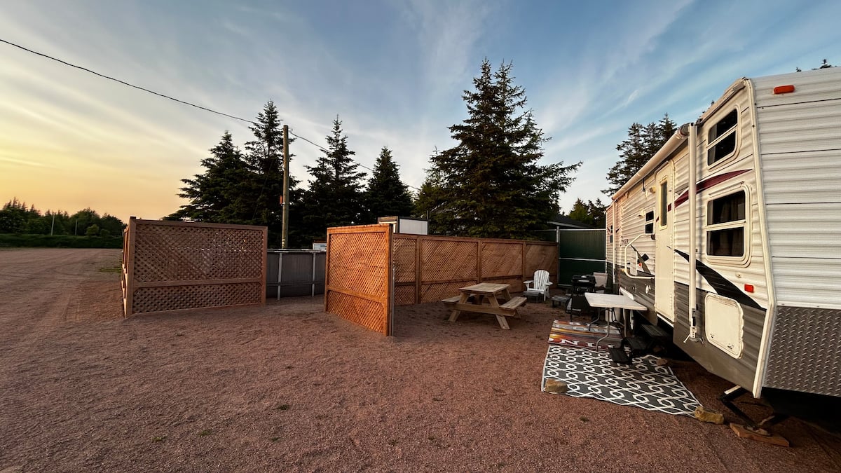 Golden-hour sunset over the camper and its privacy fence