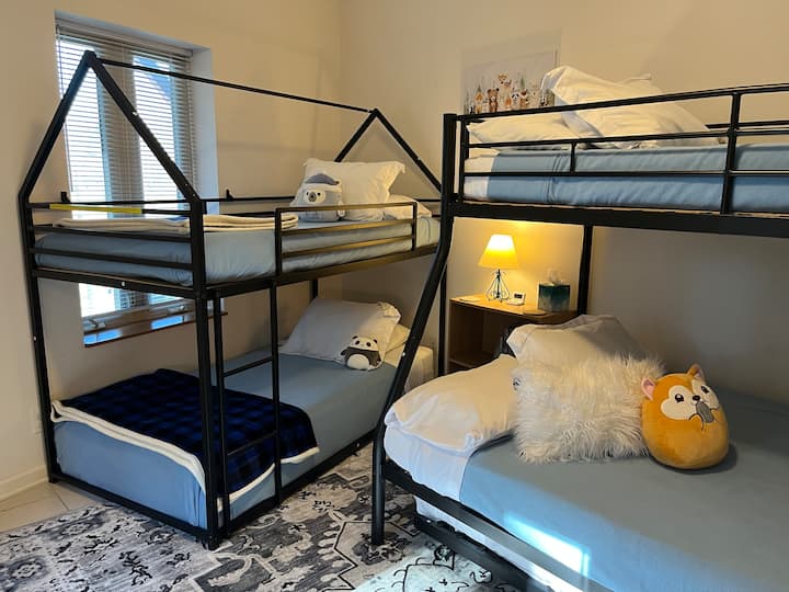 Bedroom 4 sleeps 5 guests. It has a Double/Twin bunk bed with a Twin trundle bed underneath, and a Twin/Twin Bunk bed.
