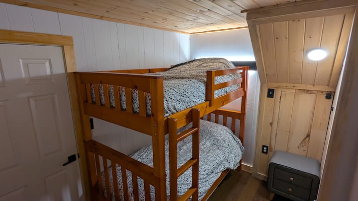 This bedroom has a twin/single bunk bed (two twin/single beds) and a dresser. We suggest that the top bunk only be used by children or smaller adults.
