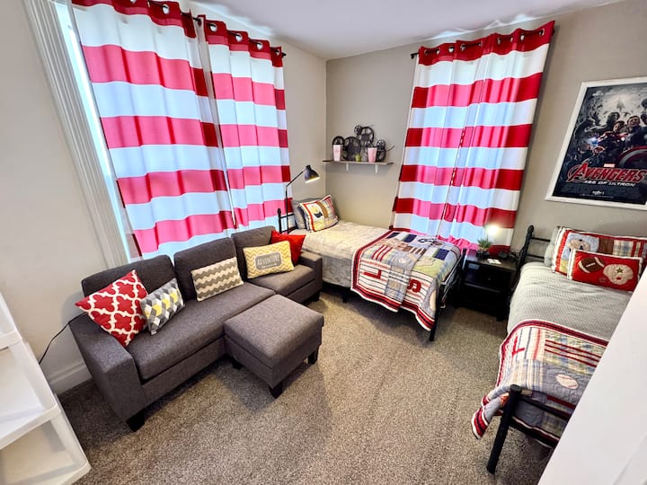 Movie & sports themed TWO Twin beds!! Bedroom (4th BR) is available on MAIN level. Has a couch (not a pullout) as well for extra person or lounging.